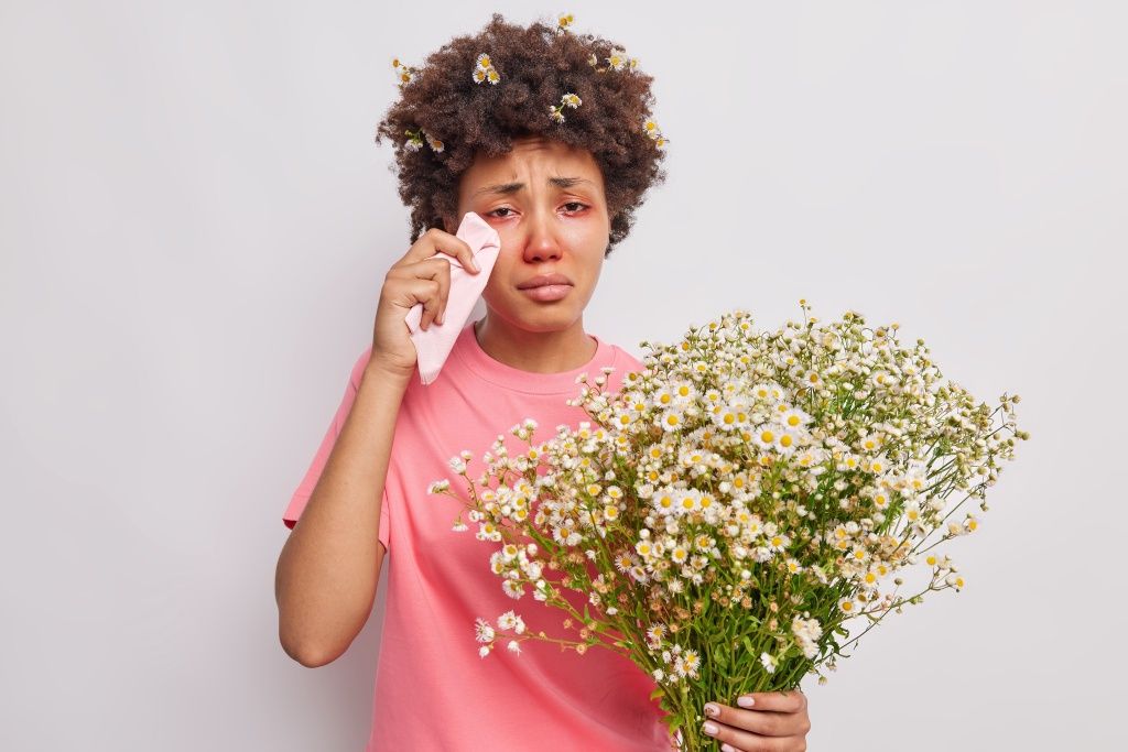 woman-rubs-red-watery-eyes-with-tissue-holds-bouquet-camomile-flowers-being-allergic-pollen-isolated-white (1) (2).jpg