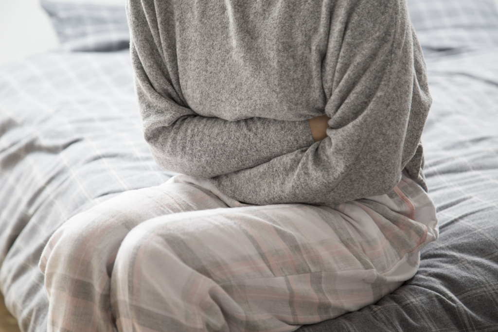 sick-woman-bed-keeping-hands-stomach-suffering-from-pain (1).jpg